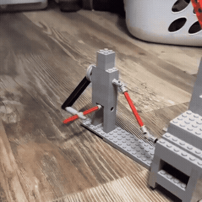 Lego Pieces On Wooden Floor With Basket GIF