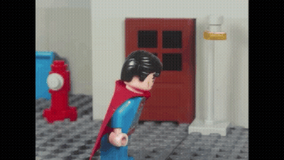 Lego Superman Standing In Front Of Red Door GIF