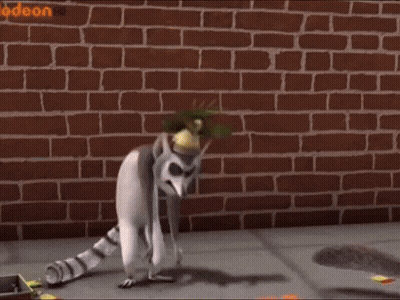Lemur Standing In Front Of Brick Wall Saying Odeon GIF