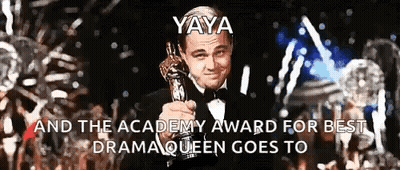 Leonardo Dicaprio Is Holding An Oscar Trophy In Front Of A Crowd Of People GIF
