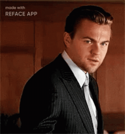 Leonardo Dicaprio Is Wearing A Suit And Tie And Making A Funny Face . GIF