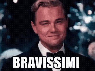 Leonardo Dicaprio Is Wearing A Tuxedo And Bow Tie And Smiling With The Words Bravissimi Written On His Face . GIF