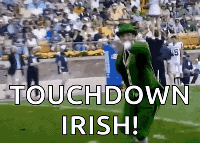 Leprechaun Blowing Kiss On Football Field With Crowd GIF
