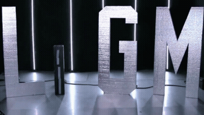 LGM Letters Displayed In Dark Room GIF