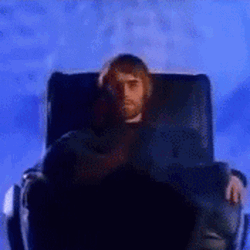 Liam Gallagher Sitting On Black Chair GIF