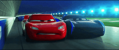 Lightning Mcqueen And Jackson Storm Racing On A Track GIF