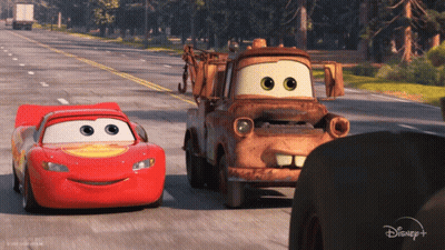 Lightning McQueen And Tow Truck Mater Driving Down Road GIF