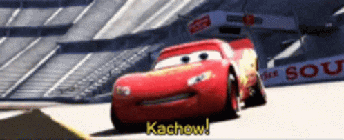 Lightning Mcqueen From Cars Is Driving Down A Race Track GIF