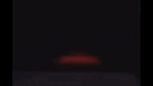 Lightning Mcqueen From Cars Is Smiling And Looking At The Camera In A Garage . GIF