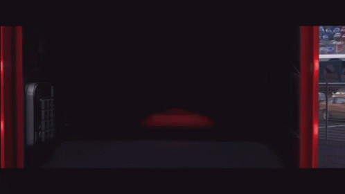 Lightning Mcqueen From The Movie Cars Is Smiling In A Garage GIF