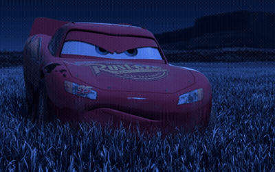 Lightning Mcqueen From The Movie Cars Is Standing In A Field Of Tall Grass GIF