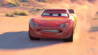 Lightning Mcqueen Is Driving Down A Dirt Road In The Desert . GIF