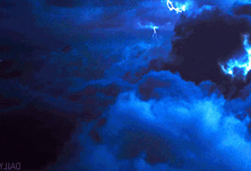 Lightning Strikes In A Dark Blue Sky With Yjiao Written On The Bottom Right GIF