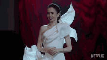 Lily Collins Excitedly Showing Off Her Dress GIF