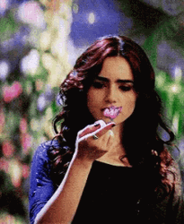 Lily Collins Looking At A Butterfly GIF
