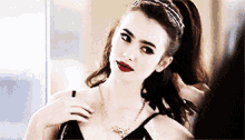 Lily Collins Posing For A Picture GIF