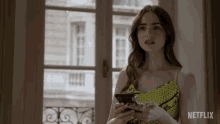 Lily Collins Sadly Looking At Her Phone GIF