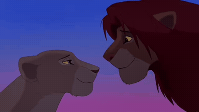 Lion And Lioness Looking At Each Other Under Blue Sky GIF