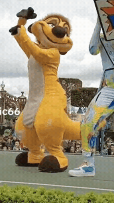 Lion King Mascot On Tennis Court With Microphone GIF