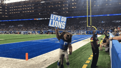 Lion Mascot Holding Let's Go Lions Sign GIF