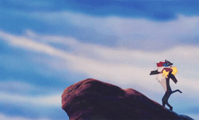 Lion Standing On Rock With Bird GIF