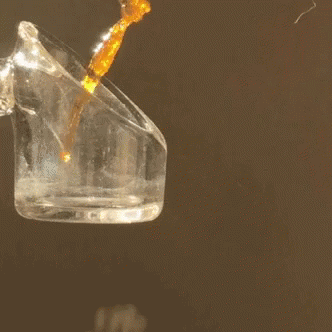 Liquid Being Poured Into Clear Glass Container GIF