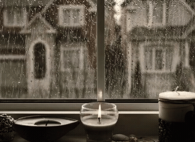 Lit Candle By Rainy Window With House GIF