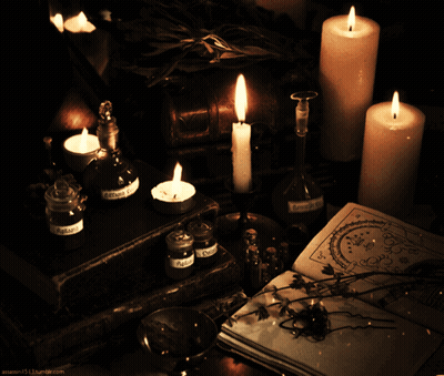 Lit Candles On Table With Potions And Book GIF