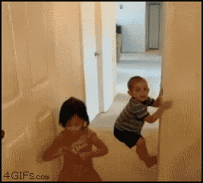 Little Boy And Little Girl Playing In Hallway GIF