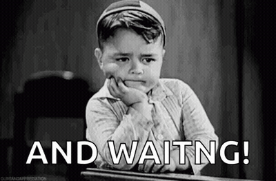 Little Boy At Desk With Hand On Chin Saying And Waiting GIF