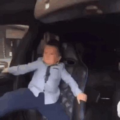 Little Boy Dancing In Back Seat Of Car GIF
