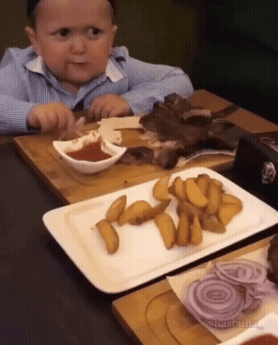 Little Boy Eating At Table GIF