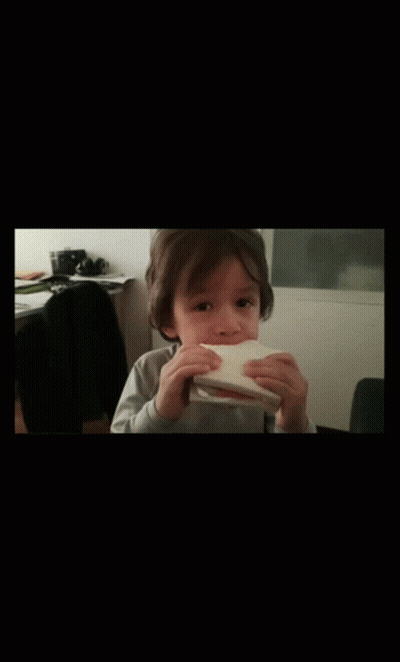 Little Boy Eating Bread With Hands GIF