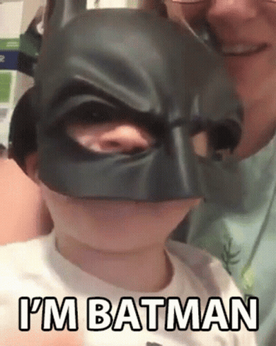 Little Boy In Batman Mask Held By Man GIF