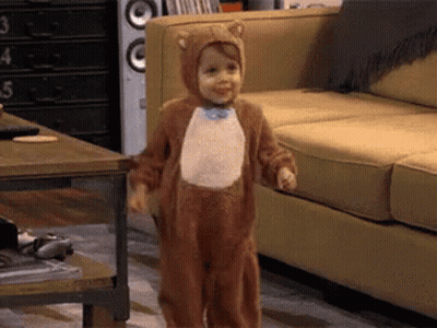 Little Boy In Bear Costume Standing In Living Room GIF