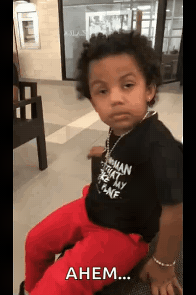 Little Boy In Black Shirt And Red Pants Making Funny Face GIF