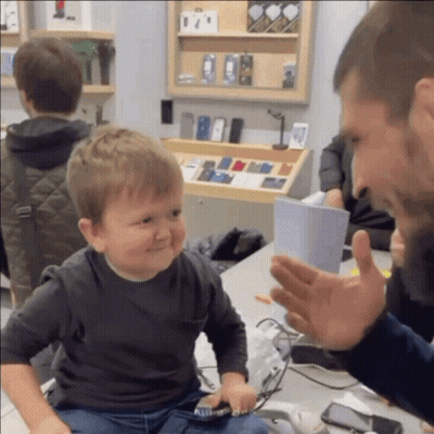 Little Boy In Front Of Phone Display GIF