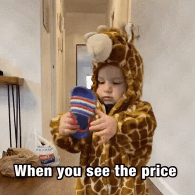 Little Boy In Giraffe Costume Holding Socks GIF