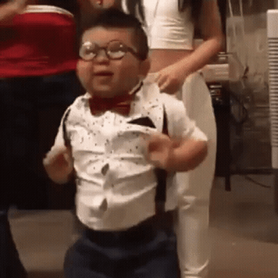 Little Boy in Glasses and Suspenders Dancing