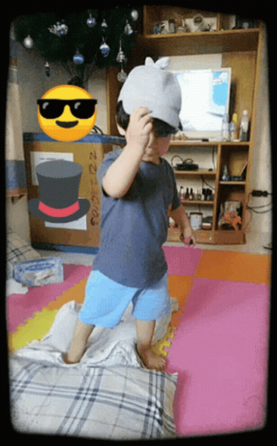 Little Boy In Hat And Sunglasses On Pillow GIF
