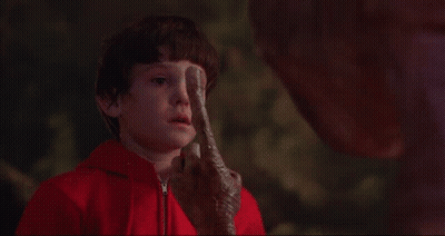 Little Boy In Red Jacket Looking At Alien With Light GIF