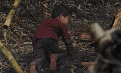 Little Boy In Red Shirt Sitting In Dirt With Arms Crossed GIF