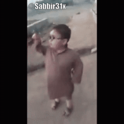 Little Boy In Sunglasses And Brown Shirt On Sidewalk GIF