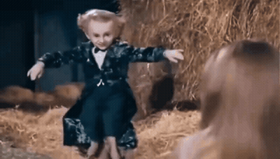 Little Boy in Tuxedo and Bow Tie Dancing in Haystack