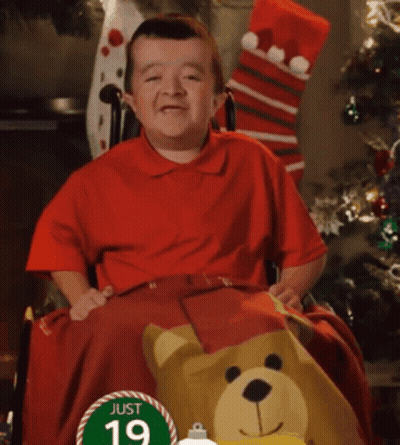 Little Boy in Wheelchair With Sign Saying Just 19