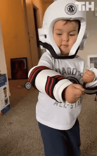 Little Boy In White Helmet With Daddy's All-Star Shirt GIF