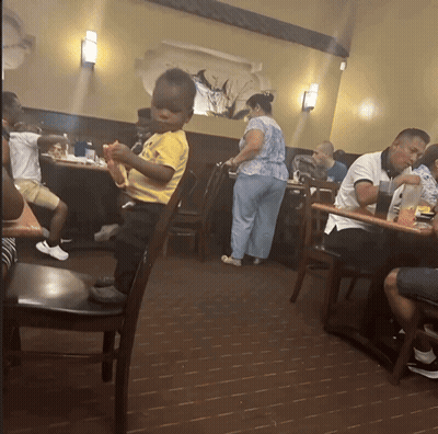 Little Boy In Yellow Shirt In Restaurant GIF