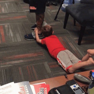 Little Boy Laying On Floor With Mississippi Football Flyer GIF