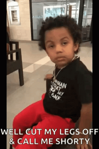 Little Boy Making Funny Face In Black Shirt And Red Pants GIF