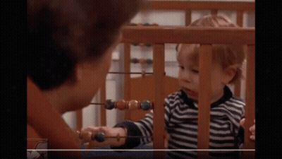 Little Boy Playing With Abacus While Woman Looks On GIF